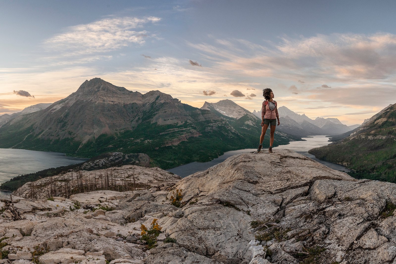 Person standing on top of mountain in Waterton Lakes National Park.