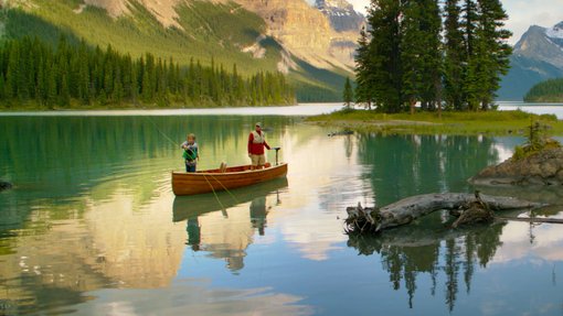 Father and son fishing in a canoe on Maligne Lake